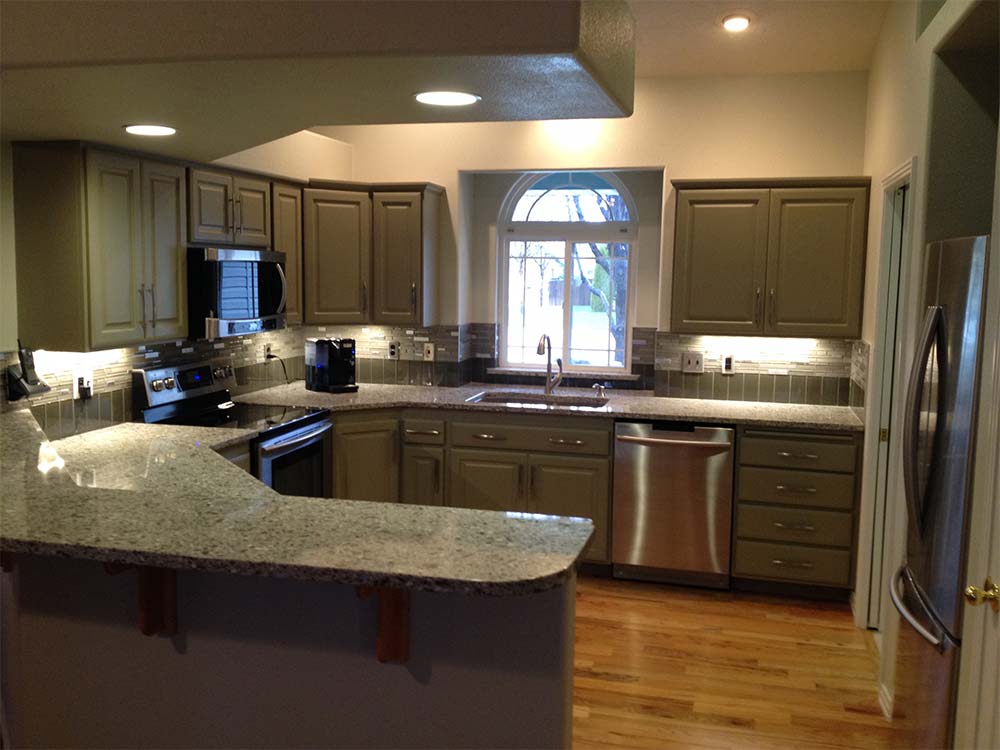 Kitchen with dark cabinets and stone countertop